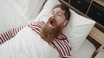 Canvas Print - Young redhead man lying on bed sleeping at bedroom