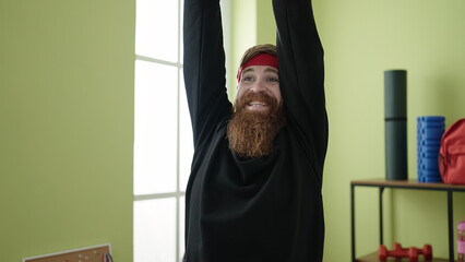 Wall Mural - Young redhead man warming up at sport center