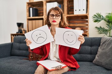 Wall Mural - Young beautiful woman working on depression holding sad to happy emotion paper depressed and worry for distress, crying angry and afraid. sad expression.