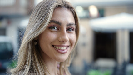 Sticker - Young blonde woman smiling confident standing at street