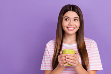 Poster - Photo of lovely adorable girl toothy smile hands hold hot chocolate cup look empty space isolated on violet color background