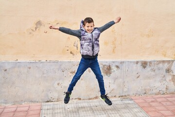 Poster - Blond child smiling confident jumping at street