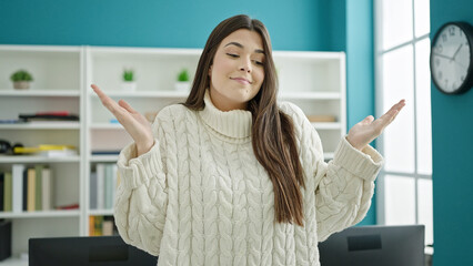 Poster - Young beautiful hispanic woman student standing with i dont know expression at university classroom