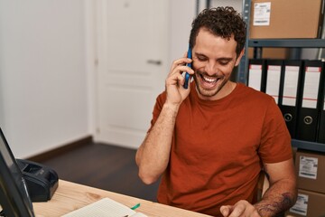 Sticker - Young hispanic man ecommerce business worker talking on the smartphone working at office