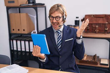 Canvas Print - Caucasian man with mustache wearing call center agent headset celebrating achievement with happy smile and winner expression with raised hand