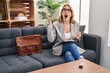 © Krakenimages.com - Hispanic woman working at consultation office crazy and mad shouting and yelling with aggressive expression and arms raised. frustration concept.