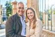 © Krakenimages.com - Middle age man and woman couple hugging each other standing at street