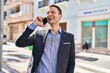 © Krakenimages.com - Young man business worker smiling confident talking on smartphone at street