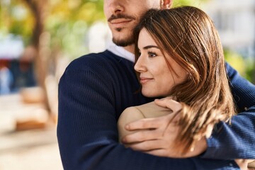 Poster - Mand and woman couple hugging each other at park