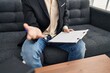© Krakenimages.com - Young caucasian man sitting on sofa speaking at office