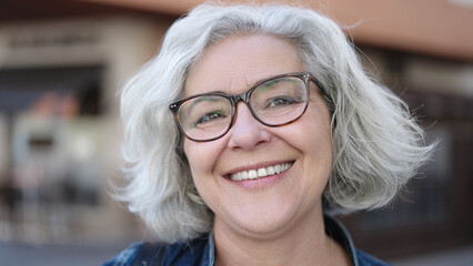 Poster - Middle age woman with grey hair smiling confident at street