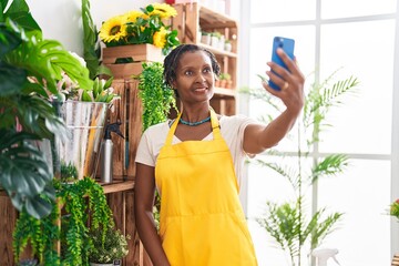 Poster - Middle age african american woman florist make selfie by smartphone at flower shop