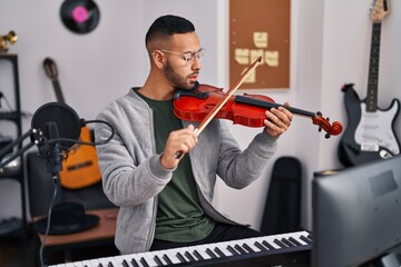 Sticker - African american man musician smiling confident playing violin at music studio