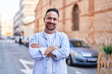 Sticker - Young caucasian man standing with arms crossed gesture at street