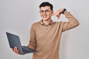 Canvas Print - Non binary person using computer laptop smiling cheerful showing and pointing with fingers teeth and mouth. dental health concept.