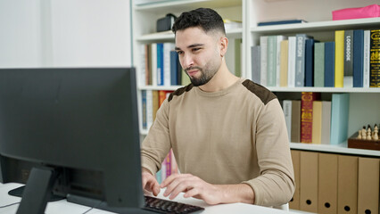 Wall Mural - Young arab man student using computer studying at university classroom