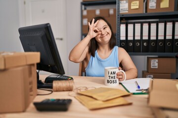 Canvas Print - Hispanic girl with down syndrome working at small business ecommerce smiling happy doing ok sign with hand on eye looking through fingers