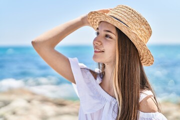 Sticker - Adorable girl tourist smiling confident wearing summer hat at seaside