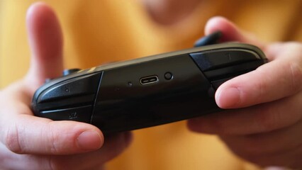 Poster - Woman hands holding black joystick gamepad playing game console. Computer gaming competition videogame control concept. Using controller playing video games. Cyberspace symbol. Hands joypad close up