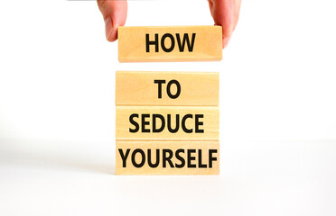Wall Mural - How to seduce yourself symbol. Concept word How to seduce yourself on wooden blocks. Businessman hand. Beautiful white table white background. Business and how to seduce yourself concept. Copy space.