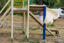 Broken Children's Slide On The Yard Playground. Background With Selective Focus