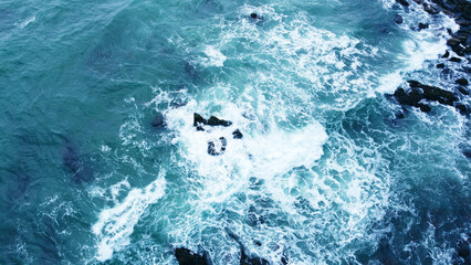 Canvas Print - Aerial view of the ocean water surface and waves. Beautiful water background texture for tourism and advertising. Tropical coast