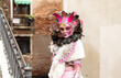 Masked lady in a white and pink costume at 2023 Venice Carnival celebrations