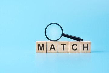 Poster - wooden blocks with the text: match with magnifying glass. business concept