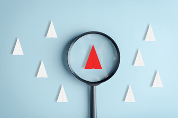 Fototapete - Magnifier focus to red paper plane leadership among white paper plane, planning development leadership and customer target group.