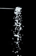 © Jade - Salt fall, crystal white grain peanuts explode abstract cloud fly from silver spoon. Beautiful complete seed salt, food object design. Selective focus freeze shot black background isolated
