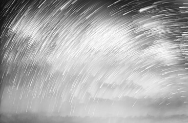 Wall Mural - Star trails in a night sky, Meteor shower in the night sky, Star long exposure, Abstract star trails in sky.