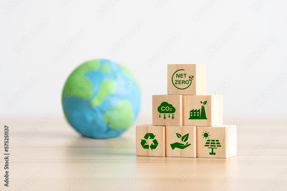 green net zero icons on wooden cubes for Carbon neutral and net zero ...