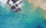 Fototapeta Łazienka - Aerial view of the ocean coast and sandy sea beach. Beautiful water background texture for tourism and advertising. Tropical coast