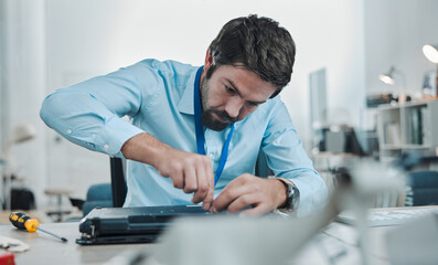 Poster - Laptop, repair and concentration with an engineer or handyman fixing hardware in an IT office. Computer, information technology or maintenance with a male service professional at work on electronics