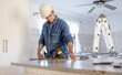 © Lumeez/peopleimages.com - Construction, measurement and handyman doing home repair, renovation and building a counter. Service, contractor and builder busy with house improvement, installation and maintenance in a kitchen