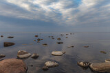 Fototapeta Morze - Baltic sea on a gloomy autumn day, view from a shore with stones.