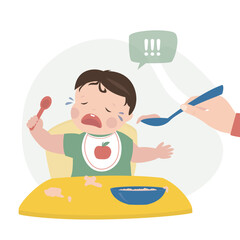 Mother or nanny trying to feed small child. The baby is crying and refuses to eat. Childhood, child care, difficulties and problems in raising young children. Hand holds spoon with food.