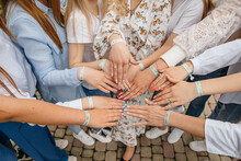 Girls' Hands In A Semicircle. Bracelets With The Inscription Of The Tribe Of The Bride. Bachelorette Party In The Circle Of Closest Friends. Details Of The Holiday