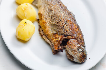 Wall Mural - grilled trout with cooked potatoes