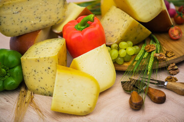 Bosnian traditional cheese served on a wooden container with peppers, parade and onions isolated on a white background