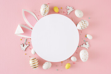 Wall Mural - Easter decor concept. Flat lay composition of white circle rabbit ears cute bunnies yellow white eggs and sprinkles on isolated pastel pink background with blank space