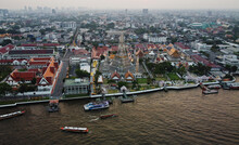 Aerial Panoramic View Of Wat Arun Buddhist Temple Located On The Bank Of Chao Phraya River, Bangkok, Thailand.