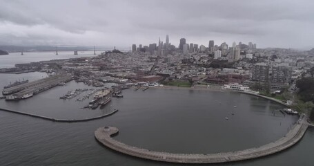 Wall Mural - San Francisco Cityscape and Fisherman's Wharf in Background. Cloudy Day. Aquatic Park Pier, Cove and Municipal Pier in San Francisco. Maritime National Historic Park in Background. California