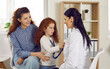 © Studio Romantic - Happy Caucasian mother with daughter at reception of woman doctor, baby girl listens to heartbeat of pediatrician through stethoscope, family physician in white coat sits in patient apartment