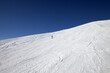 Skier on slope in sun day