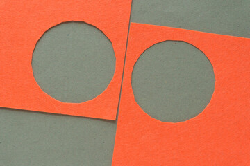 Canvas Print - two orange felt shapes with roughly cutout circle shapes on green paper