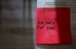 © ariya j - Red sticky note with text written I'M HERE FOR YOU   - concept of a cheer up note to someone to encourage them in a bad day