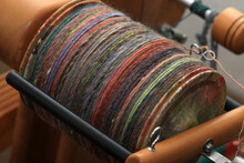 Closeup Detail Of Colourful Organic Natural Handspun And Handdyed Merino Sheep Wool Yarn , Spun On A Traditional Spinning Wheel