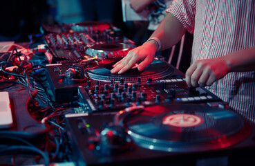 Wall Mural - Hip hop dj scratching vinyl record on turntable. Close up photo of club disc jockey mixing records on a party