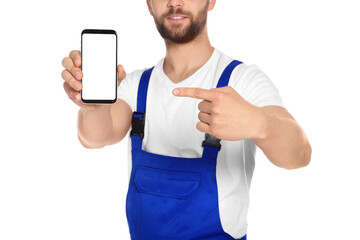 Wall Mural - Professional repairman in uniform showing smartphone on white background, closeup